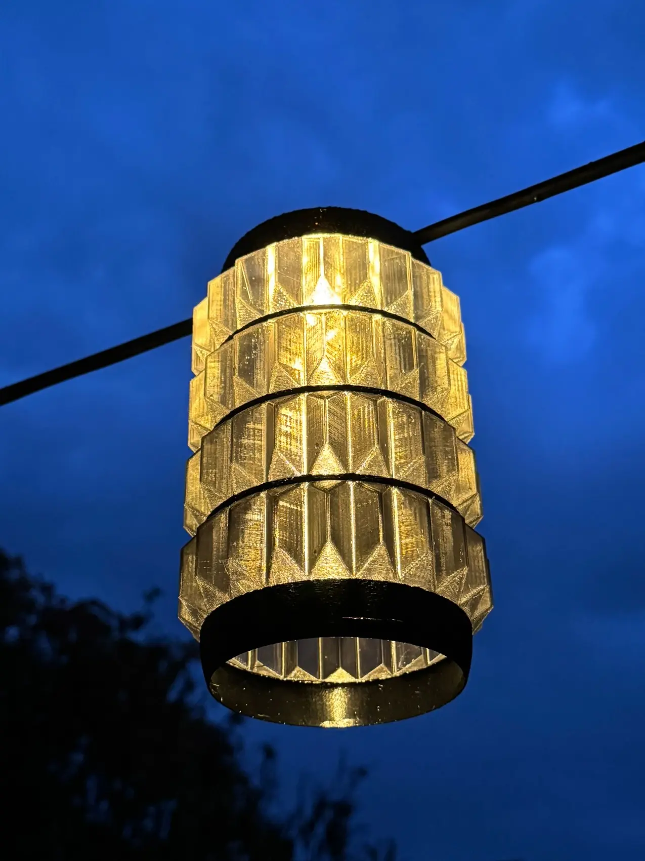 A sculptural additive-manufactured gold lighting shade