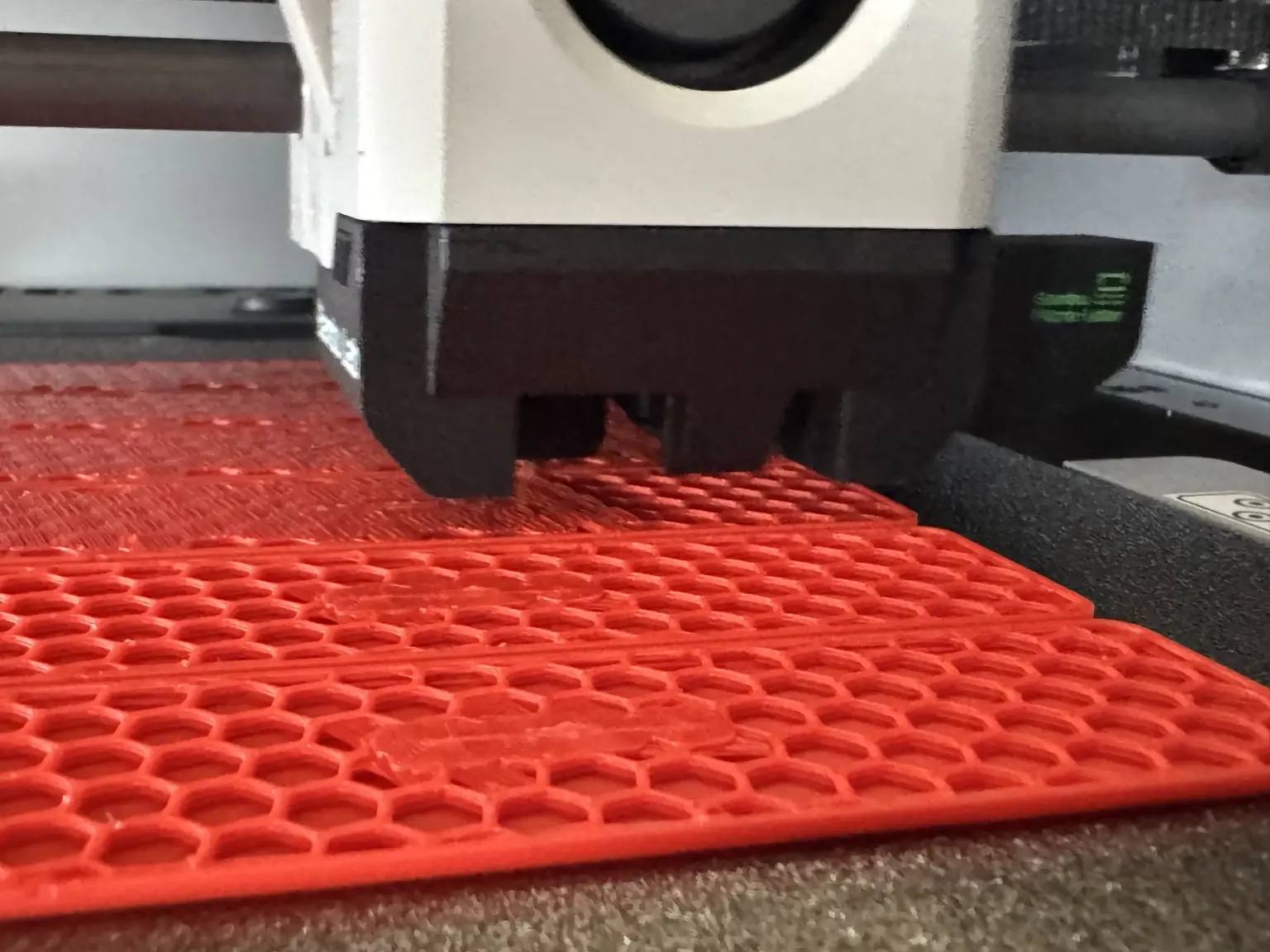 A batch of red protective components being manufactured